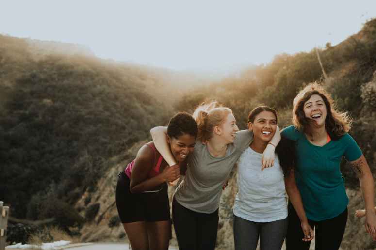 four women standing on mountain
